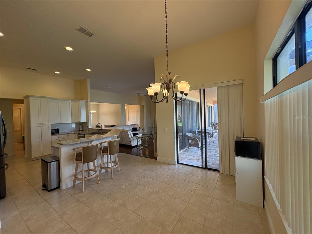 898 San Raphael Street Poinciana, FL 34759 - Photo 15 of 37 a large kitchen with a table and chairs