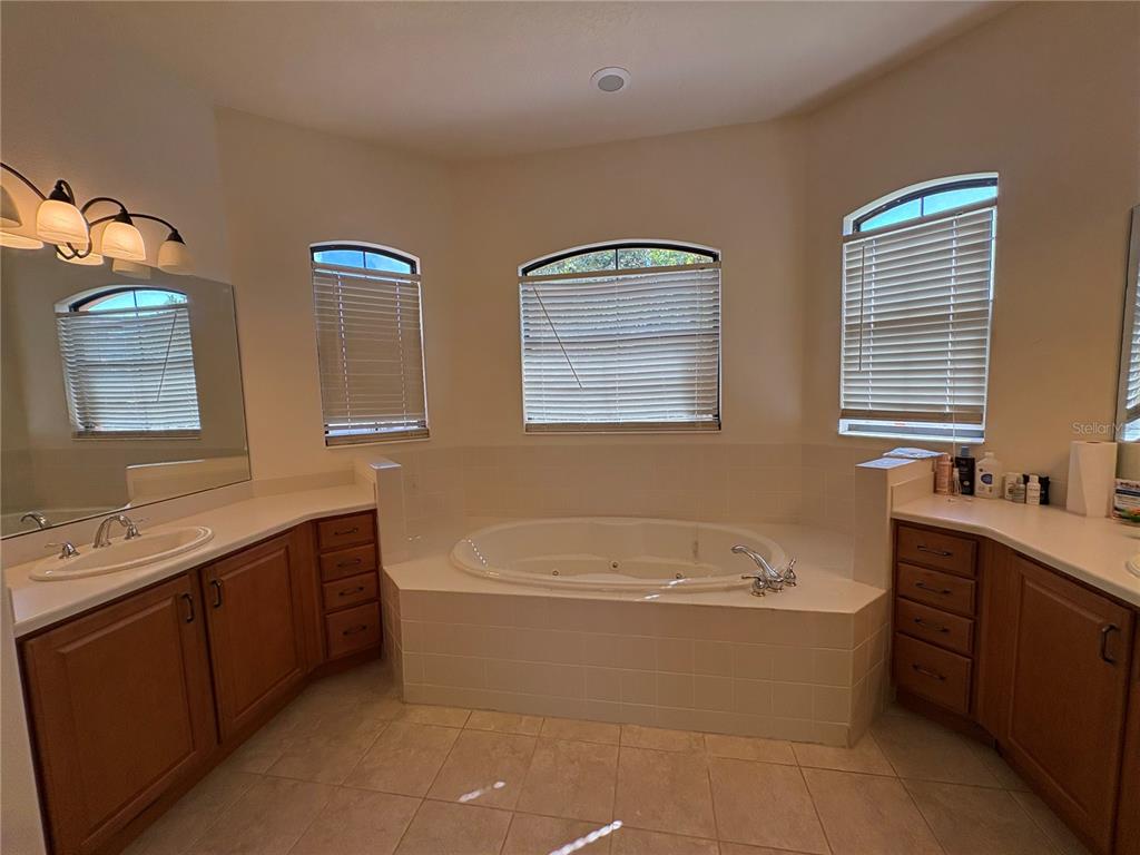 898 San Raphael Street Poinciana, FL 34759 - Photo 20 of 37 a bathroom with a tub sink and mirror