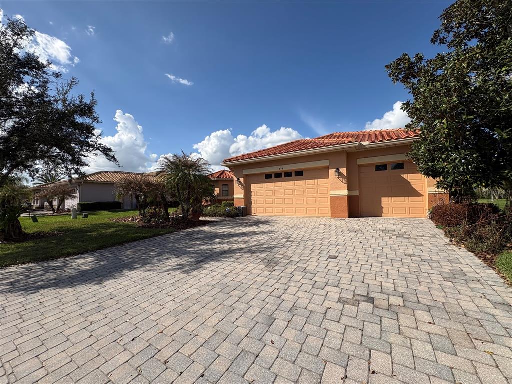 898 San Raphael Street Poinciana, FL 34759 - Photo 27 of 37 a front view of a house with a yard