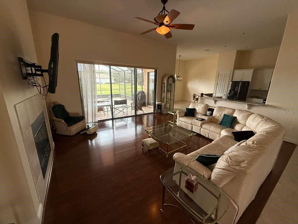 898 San Raphael Street Poinciana, FL 34759 - Photo 4 of 37 a living room with furniture a flat screen tv and a large window
