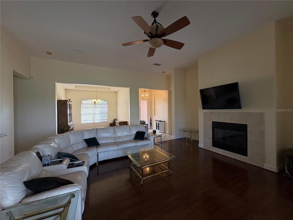898 San Raphael Street Poinciana, FL 34759 - Photo 5 of 37 a living room with furniture floor to ceiling window and a fireplace