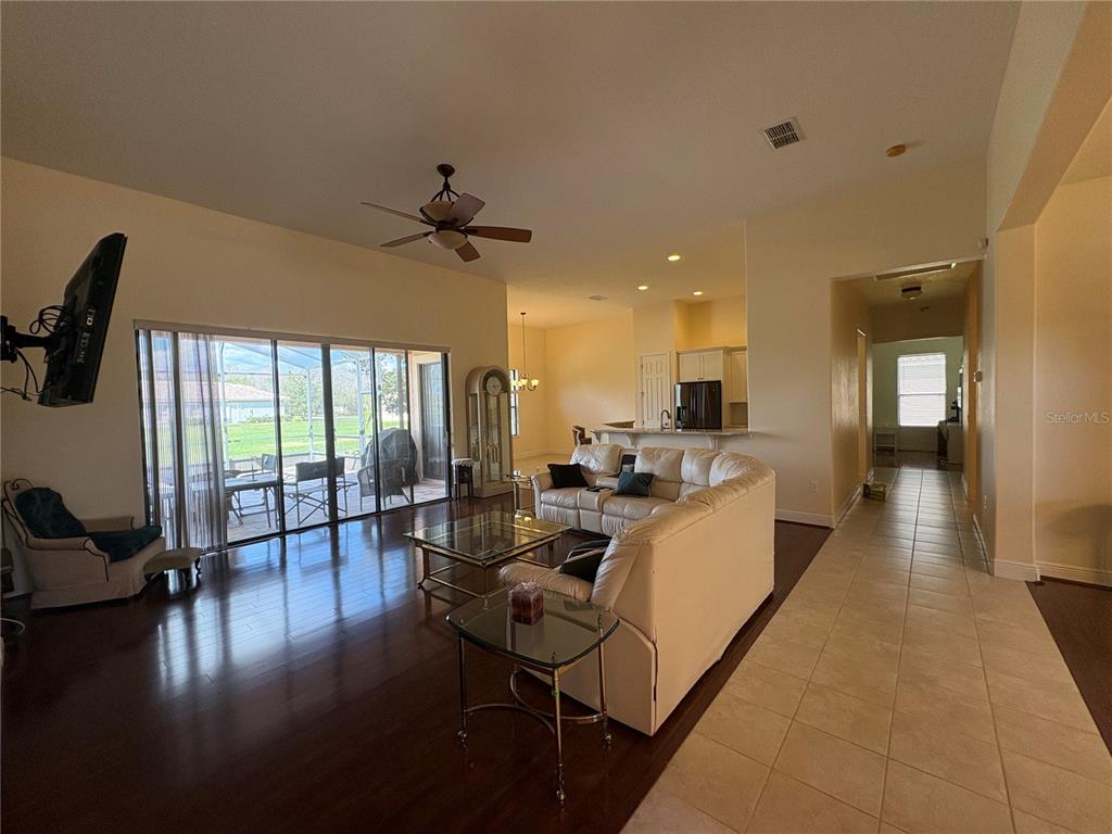 898 San Raphael Street Poinciana, FL 34759 - Photo 9 of 37 a living room with furniture a flat screen tv and a large window