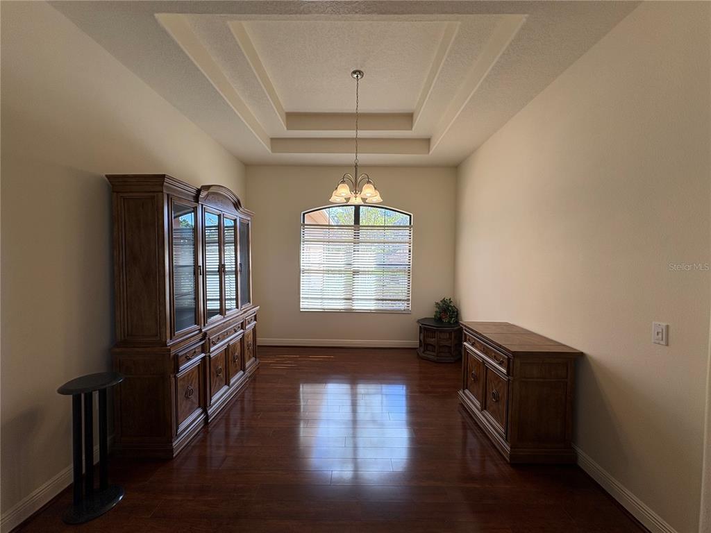 898 San Raphael Street Poinciana, FL 34759 - Photo 10 of 37 wooden floor in an empty room with a window