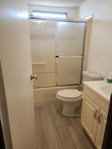 a white toilet sitting next to a bathroom sink