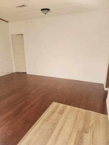 a view of a house with a yard and a chair