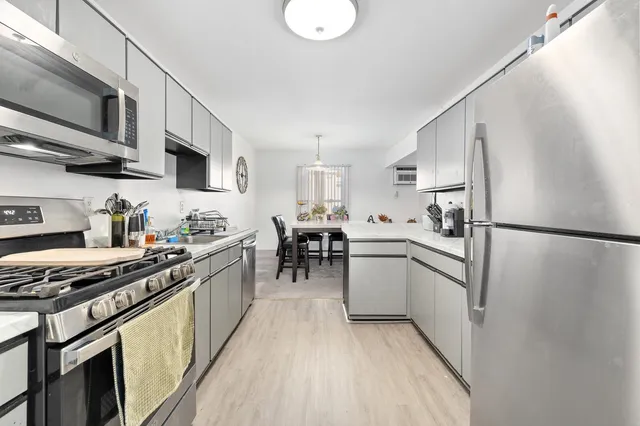 a kitchen with stainless steel appliances granite countertop a refrigerator stove microwave and sink