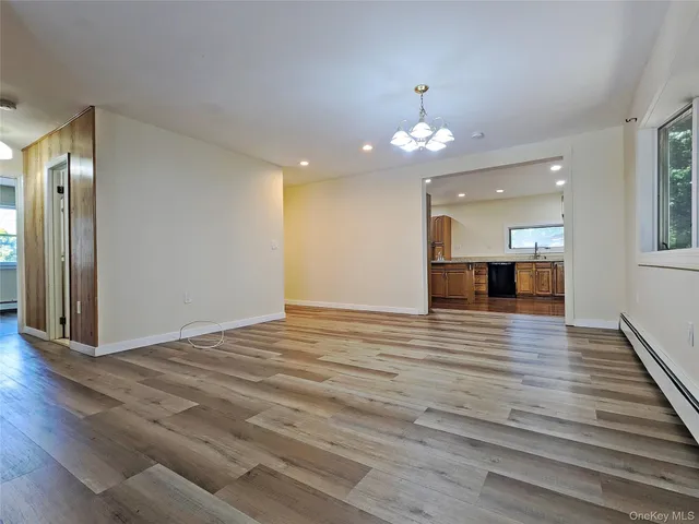 a view of a livingroom with wooden floor and staircase
