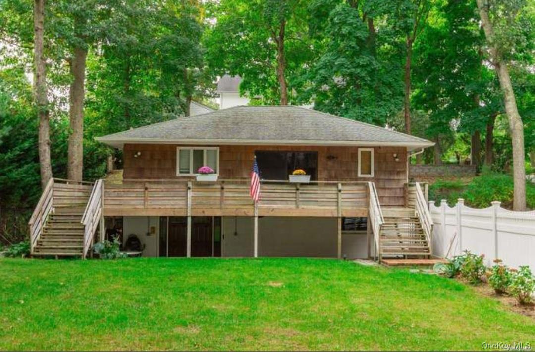 31 Apricot Road Rocky Point, NY 11778 - Photo 1 of 1 Back of property with stairway, a wooden deck, and roof with shingles