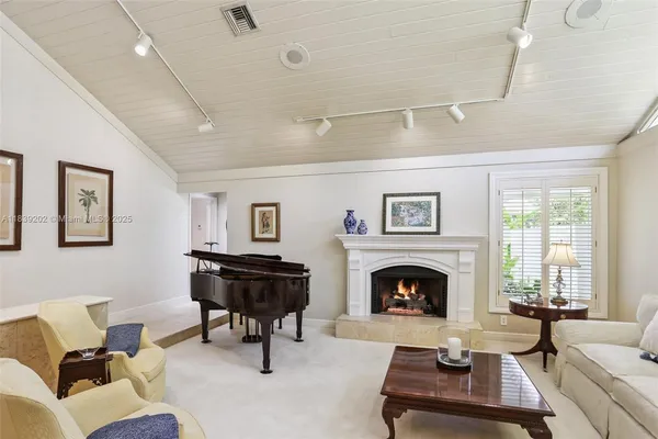 a living room with furniture fireplace and window