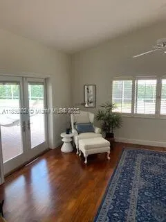 a living room with furniture and wooden floor