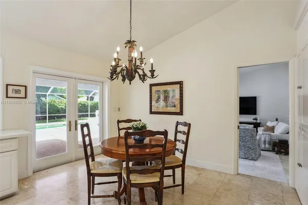 a view of a dining room with furniture and chandelier