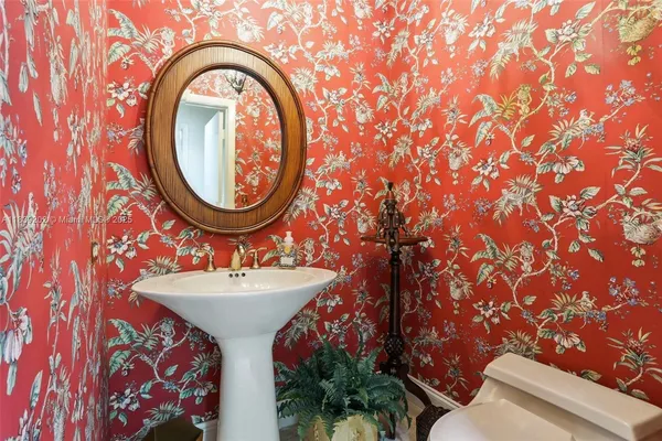 a kitchen with a sink cabinets and chair