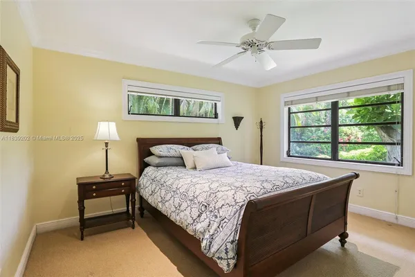 an aerial view of residential houses with outdoor space and trees