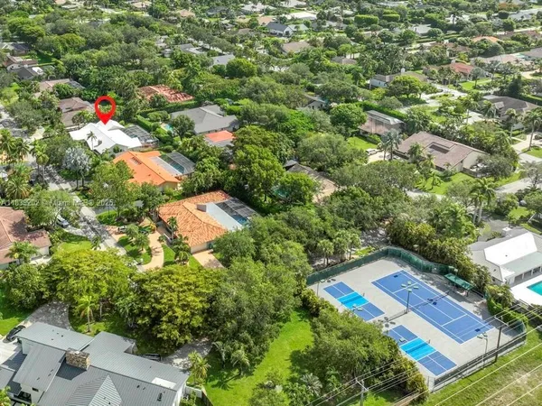 an aerial view of a house with a yard