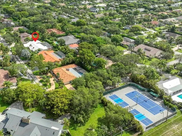 an aerial view of a house with a yard
