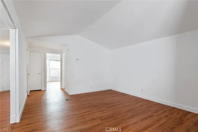a view of a room with wooden floor