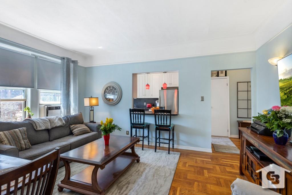 7201 4th Avenue, Unit D2 Brooklyn, NY 11209 - Photo 4 of 6 a living room with furniture and a potted plant