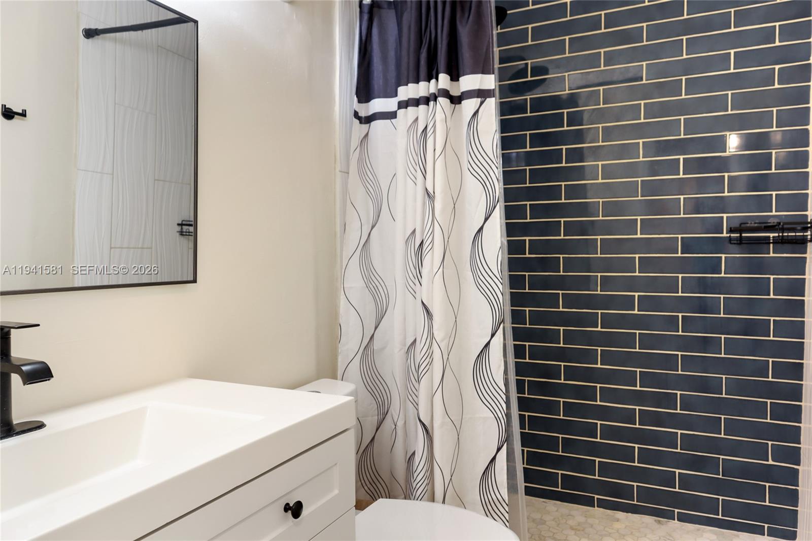 14009 Southwest 84th Street Miami, FL 33183 - Photo 11 of 15 a bathroom with a sink toilet and shower