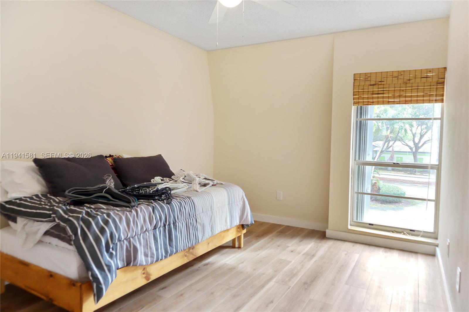 14009 Southwest 84th Street Miami, FL 33183 - Photo 12 of 15 a bedroom with a bed and wooden floor
