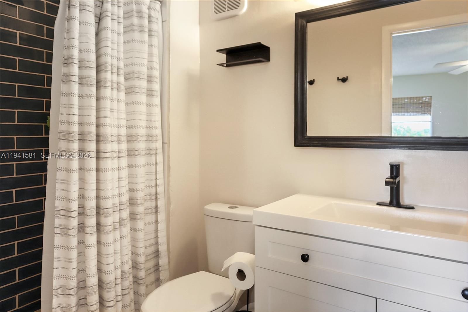 14009 Southwest 84th Street Miami, FL 33183 - Photo 13 of 15 a bathroom with a sink toilet and shower