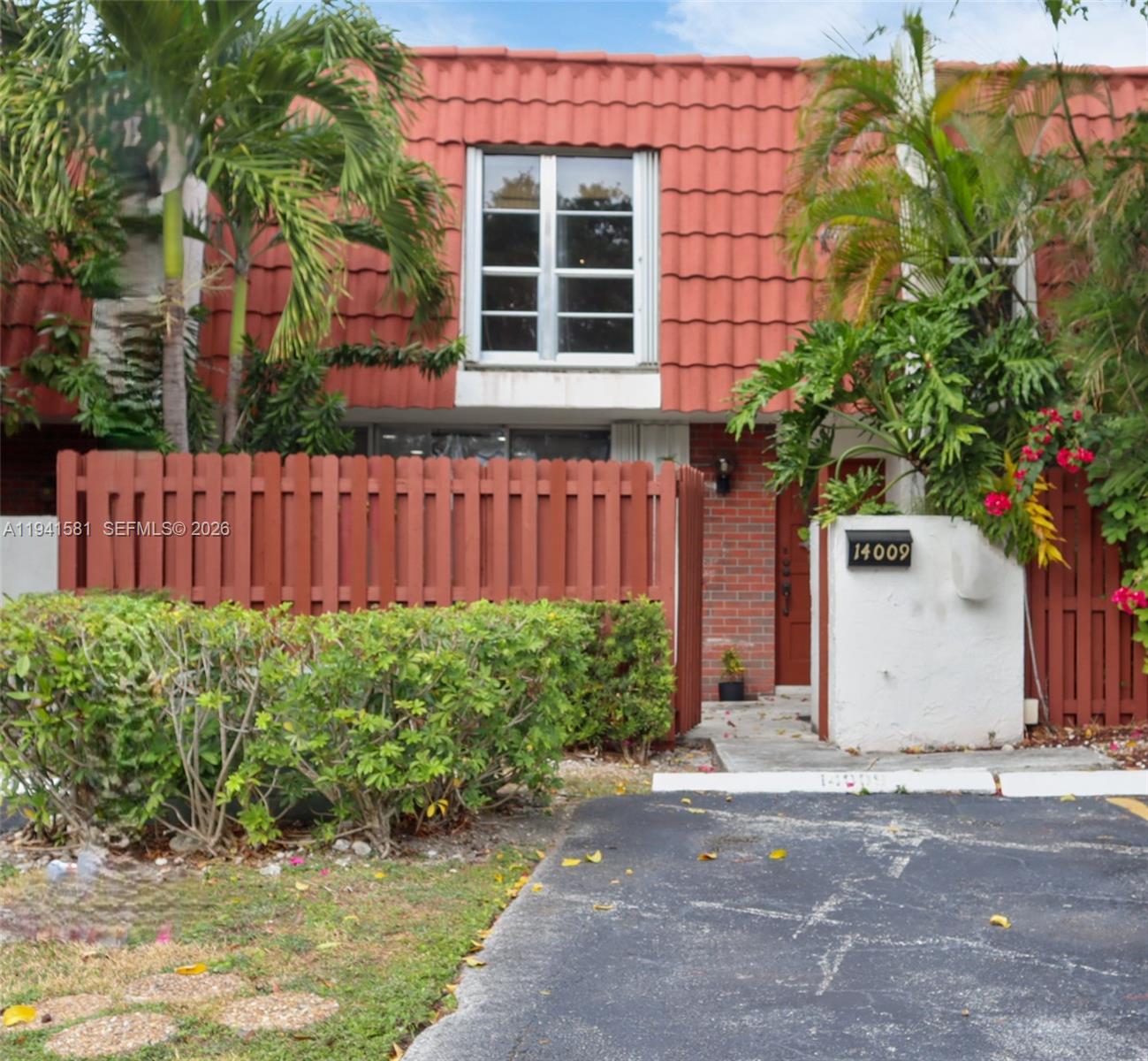 14009 Southwest 84th Street Miami, FL 33183 - Photo 2 of 15 a front view of a house with a garden