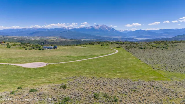 a view of a lush green hillside and a houses