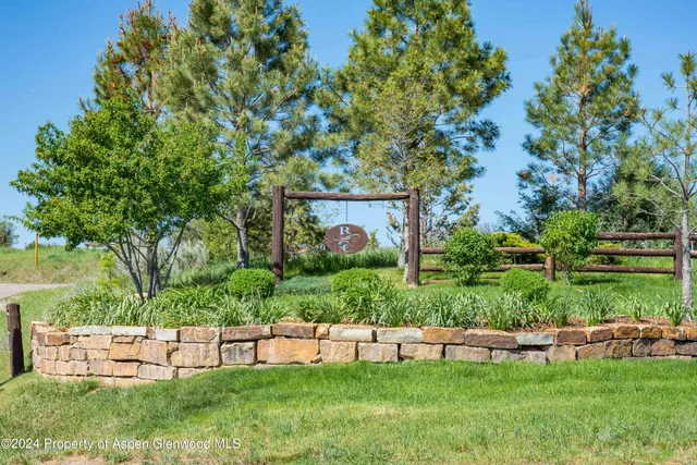 a view of an house with a garden and sitting area