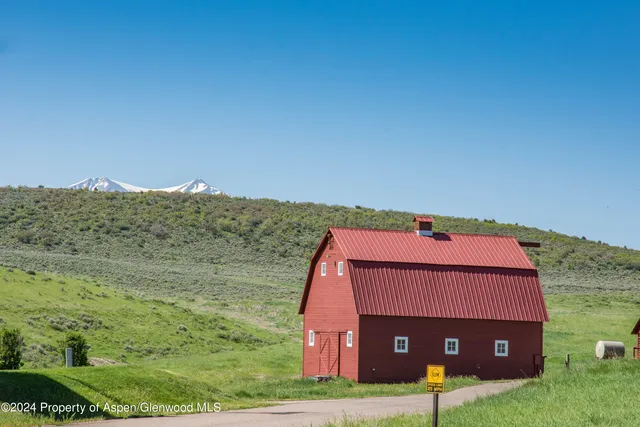 a view of a big house with a big yard