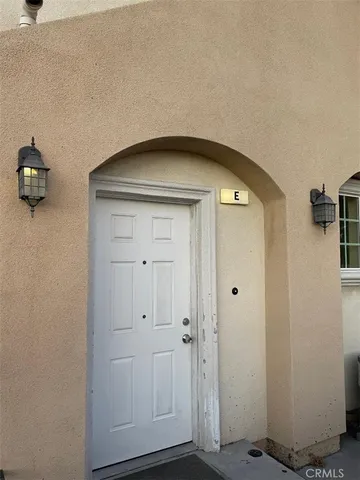 an empty room with wooden floor & closet area