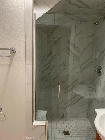 a white toilet sitting next to a shower