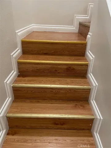 a large kitchen with stainless steel appliances granite countertop a large counter top and a wooden floors