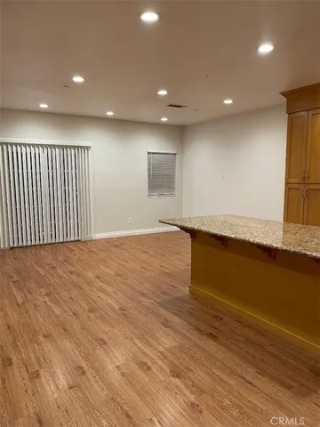 a bathroom with a granite countertop sink a toilet and a mirror