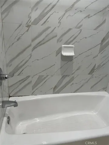 a view of an empty room with wooden floor and closet