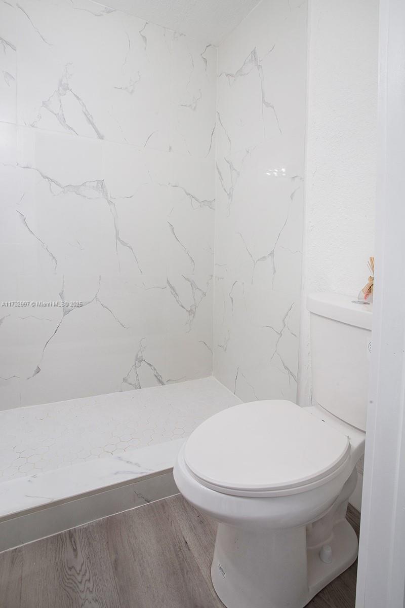 1923 Northwest 66th Street Miami, FL 33147 - Photo 17 of 29 a white toilet sitting next to a bath tub