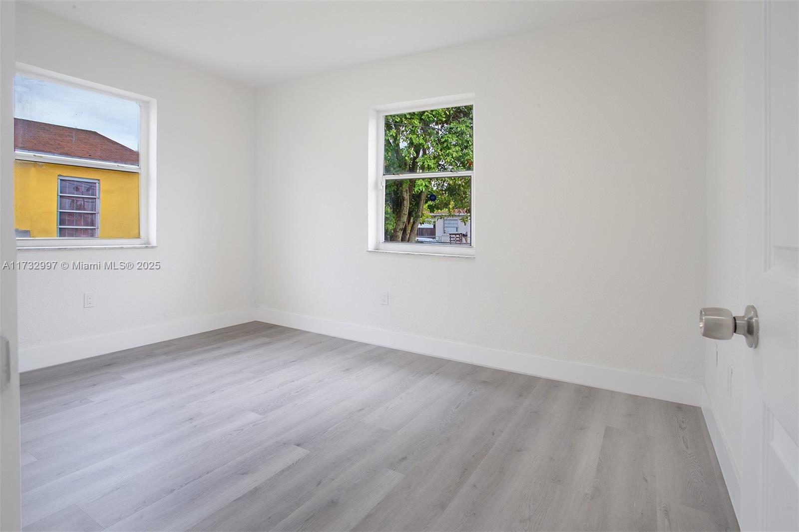 1923 Northwest 66th Street Miami, FL 33147 - Photo 18 of 29 an empty room with a window