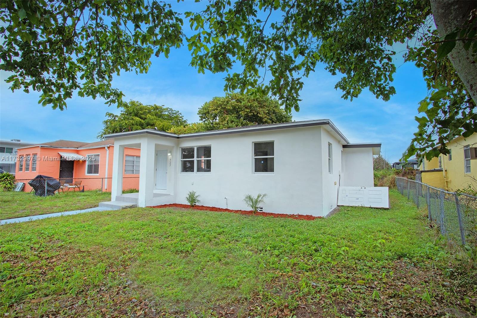 1923 Northwest 66th Street Miami, FL 33147 - Photo 2 of 29 a view of a house with a yard