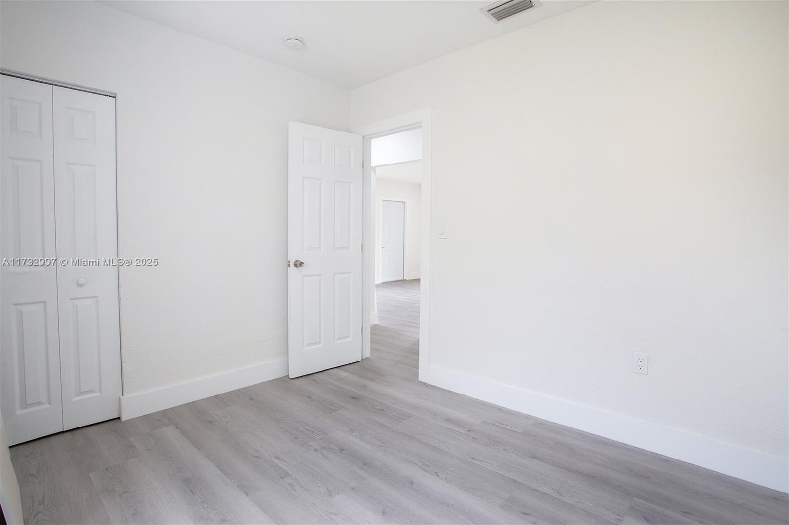 1923 Northwest 66th Street Miami, FL 33147 - Photo 22 of 29 an empty room with wooden floor
