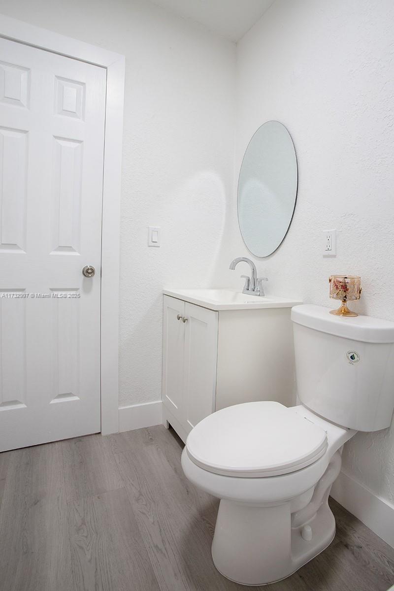 1923 Northwest 66th Street Miami, FL 33147 - Photo 24 of 29 a white toilet sitting next to a bathroom sink
