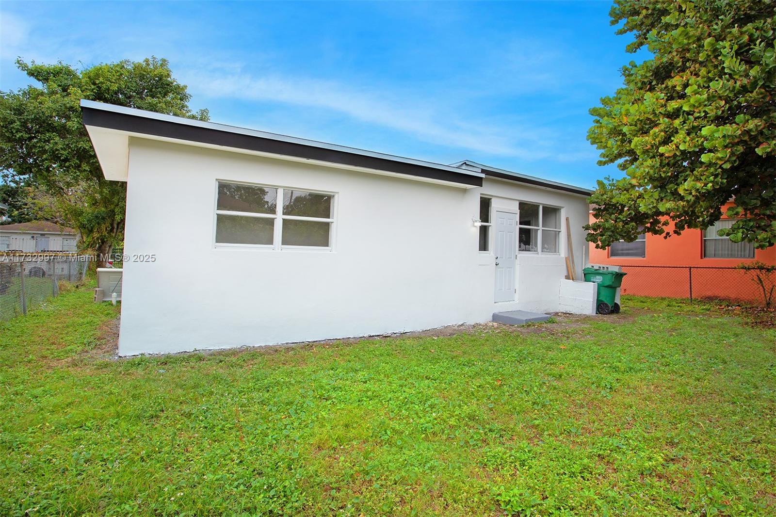 1923 Northwest 66th Street Miami, FL 33147 - Photo 25 of 29 a backyard of a house with plants and large tree