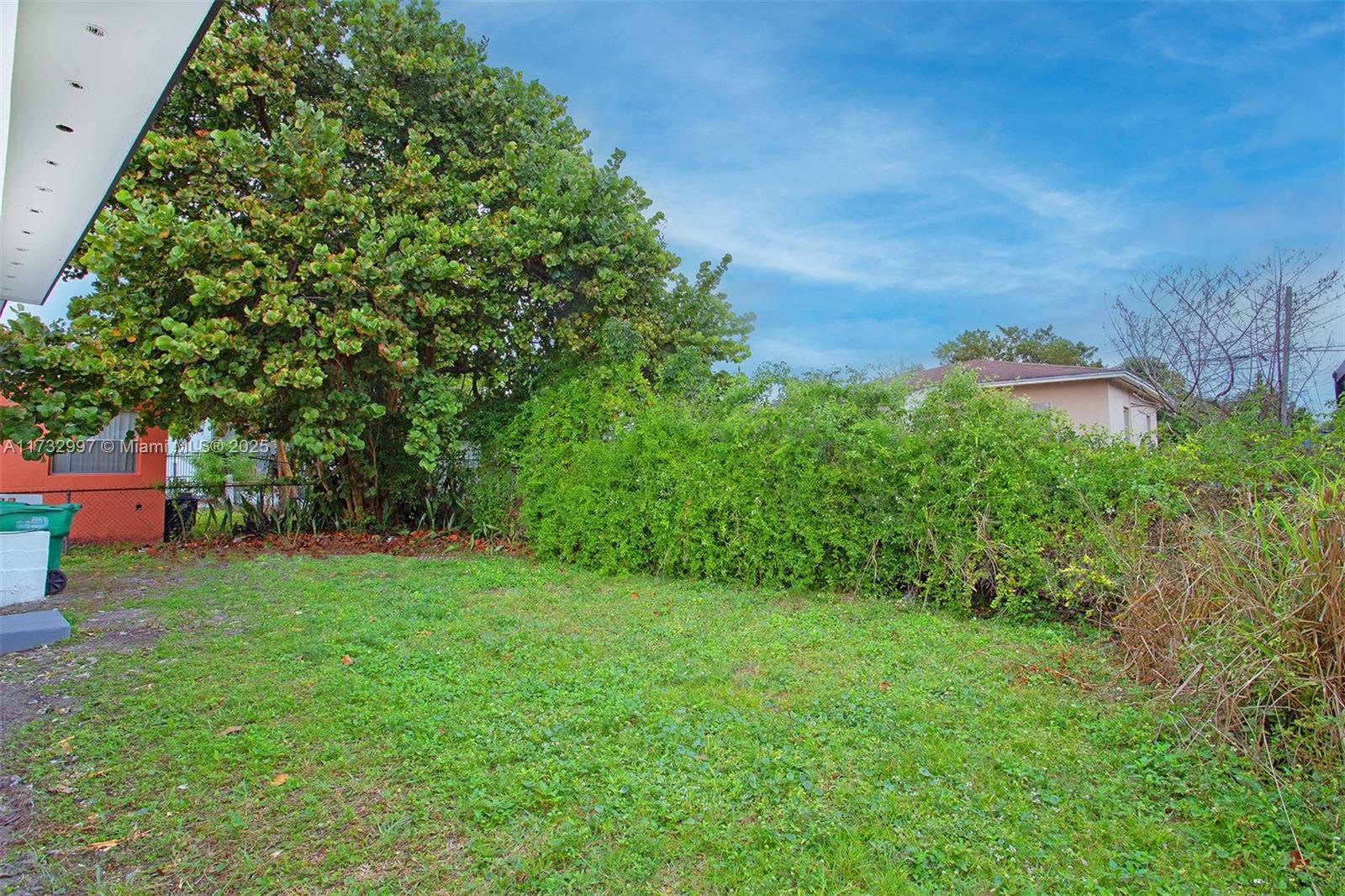 1923 Northwest 66th Street Miami, FL 33147 - Photo 29 of 29 a backyard of a house with lots of green space