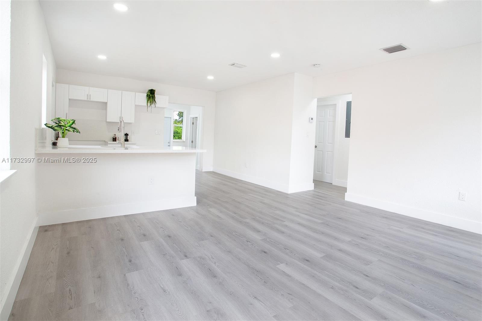 1923 Northwest 66th Street Miami, FL 33147 - Photo 3 of 29 a view of kitchen with wooden floor and electronic appliances