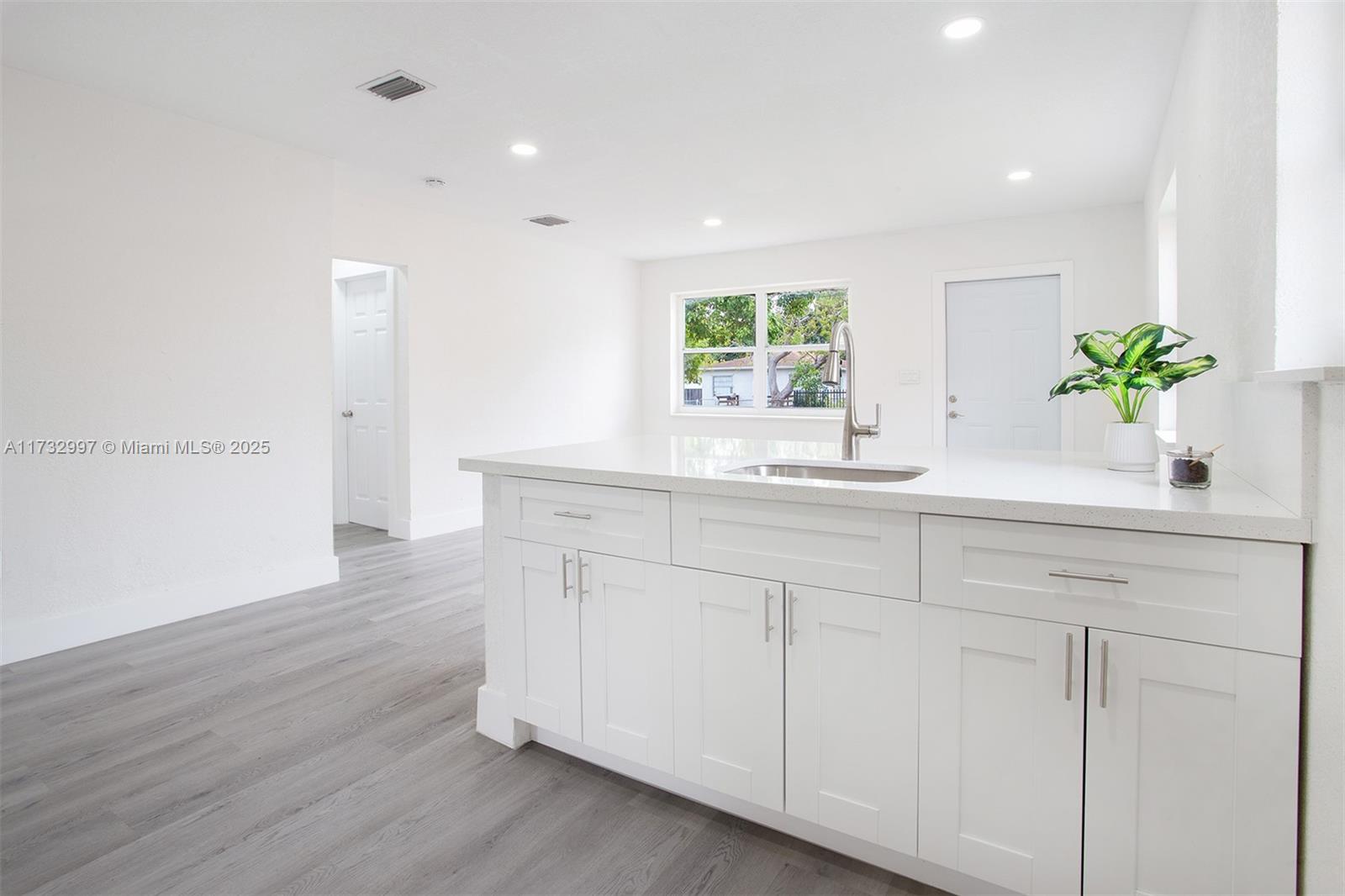 1923 Northwest 66th Street Miami, FL 33147 - Photo 5 of 29 a kitchen with a sink and cabinets