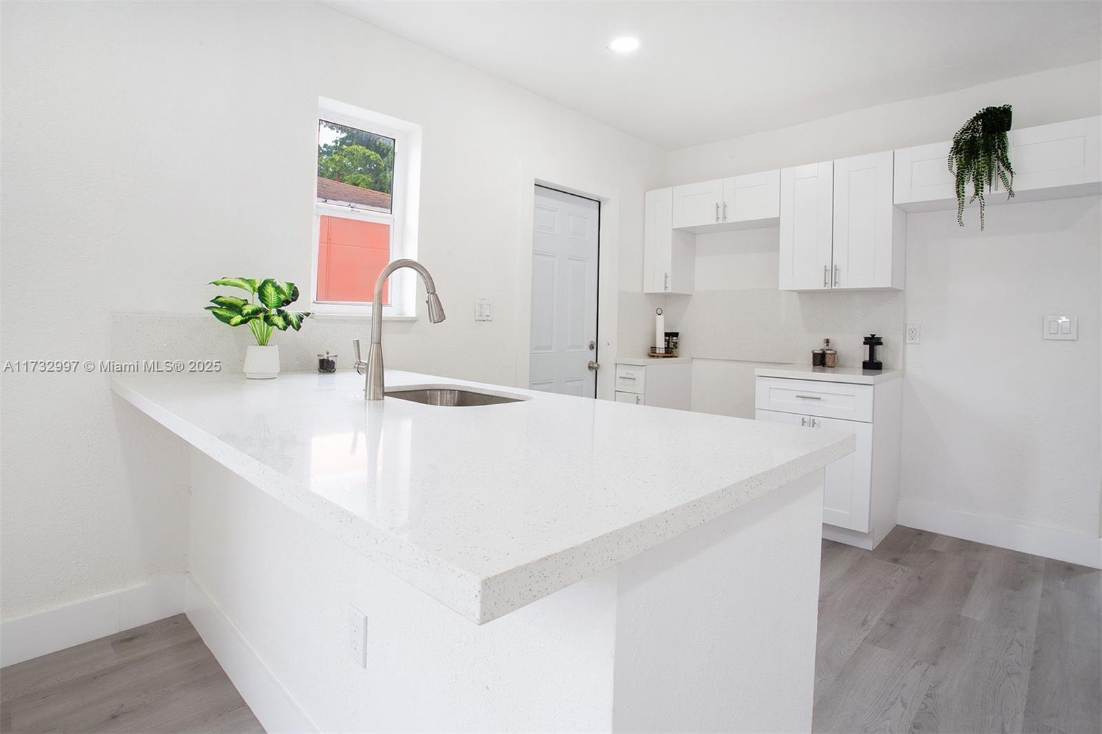 1923 Northwest 66th Street Miami, FL 33147 - Photo 7 of 29 a kitchen with a sink and cabinets