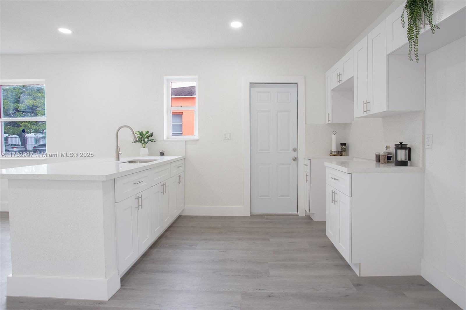 1923 Northwest 66th Street Miami, FL 33147 - Photo 9 of 29 a view of a kitchen with white cabinets