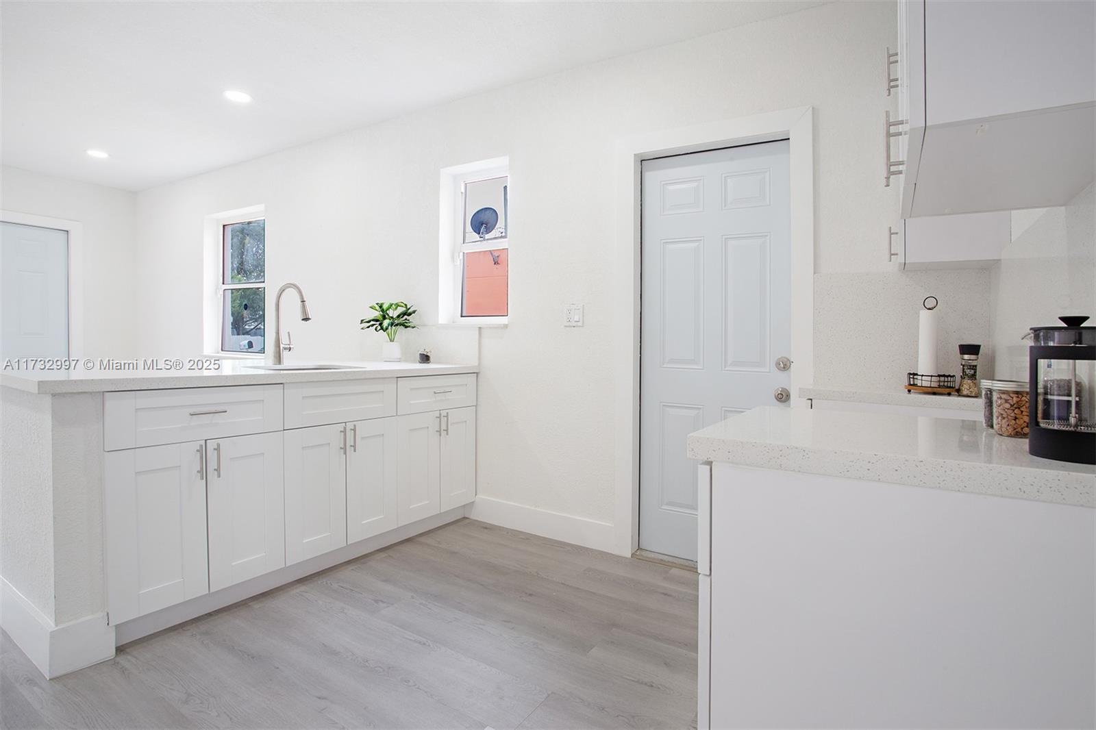 1923 Northwest 66th Street Miami, FL 33147 - Photo 10 of 29 a kitchen with a sink and cabinets