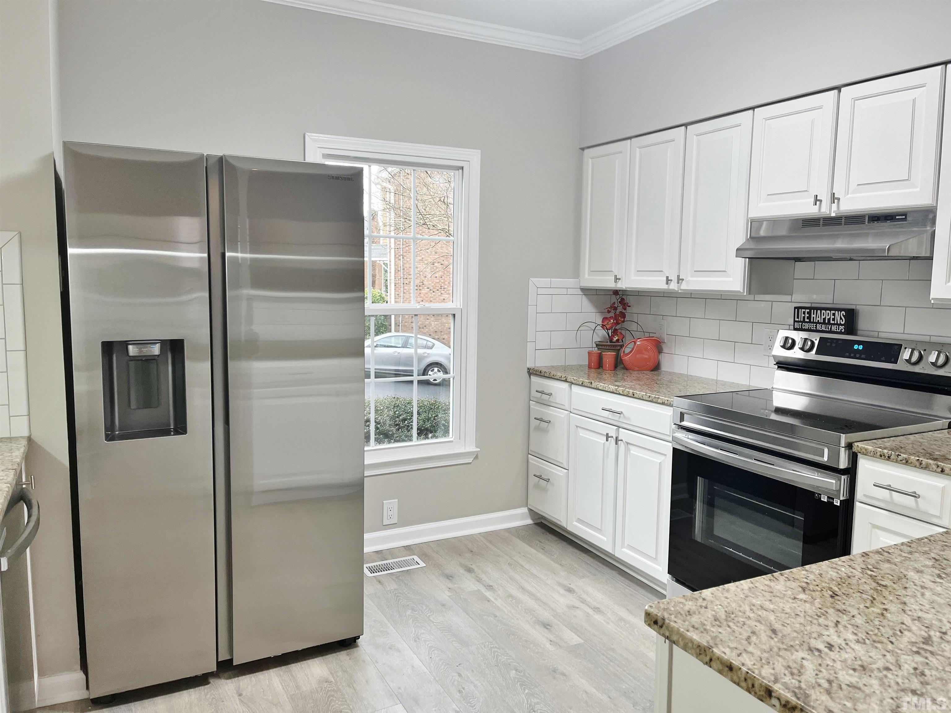6123 Bushmills Street Raleigh, NC 27613 - Photo 5 of 16 a kitchen with stainless steel appliances granite countertop a refrigerator sink and stove