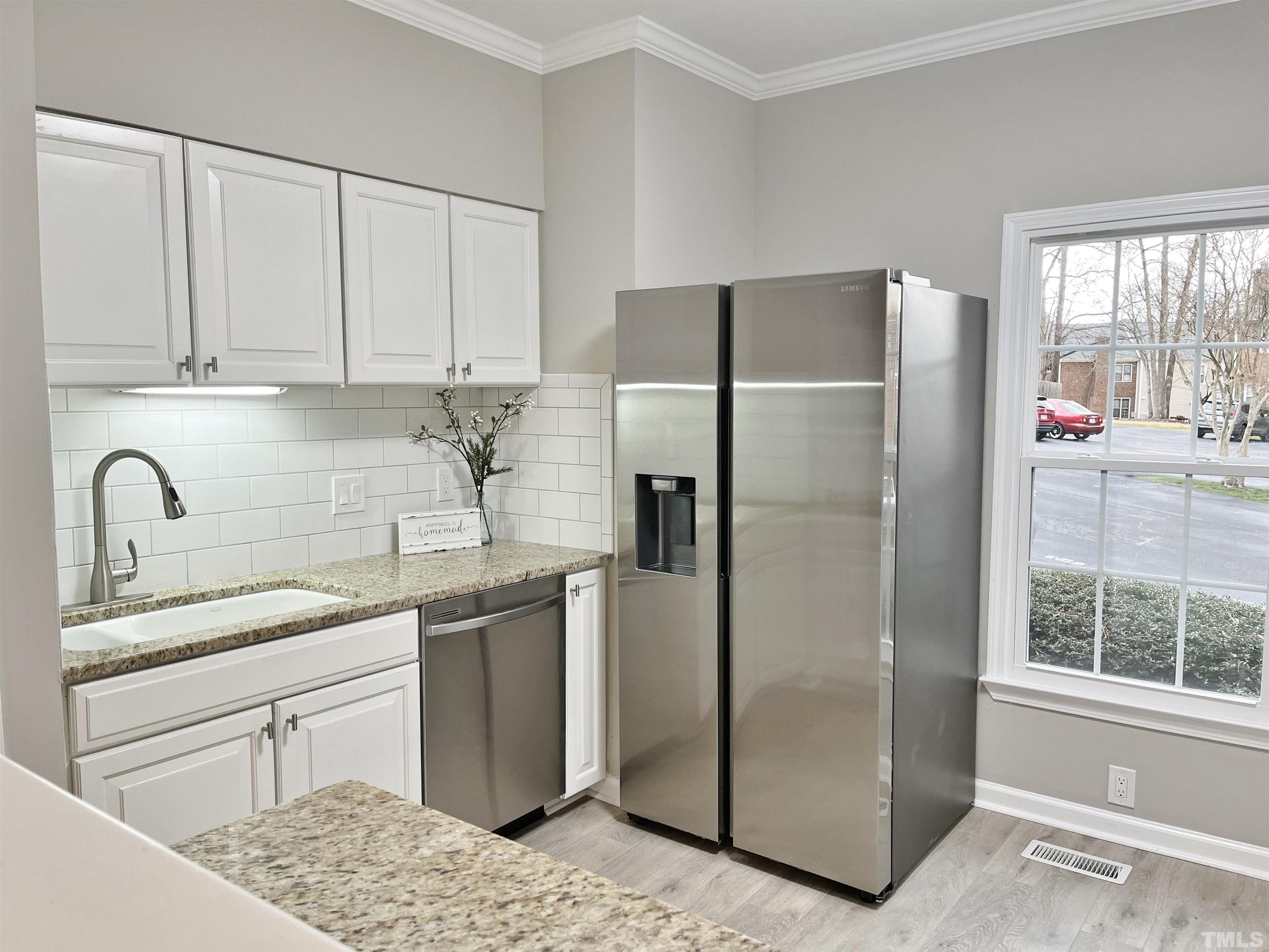 6123 Bushmills Street Raleigh, NC 27613 - Photo 6 of 16 a kitchen with stainless steel appliances granite countertop a refrigerator and a sink