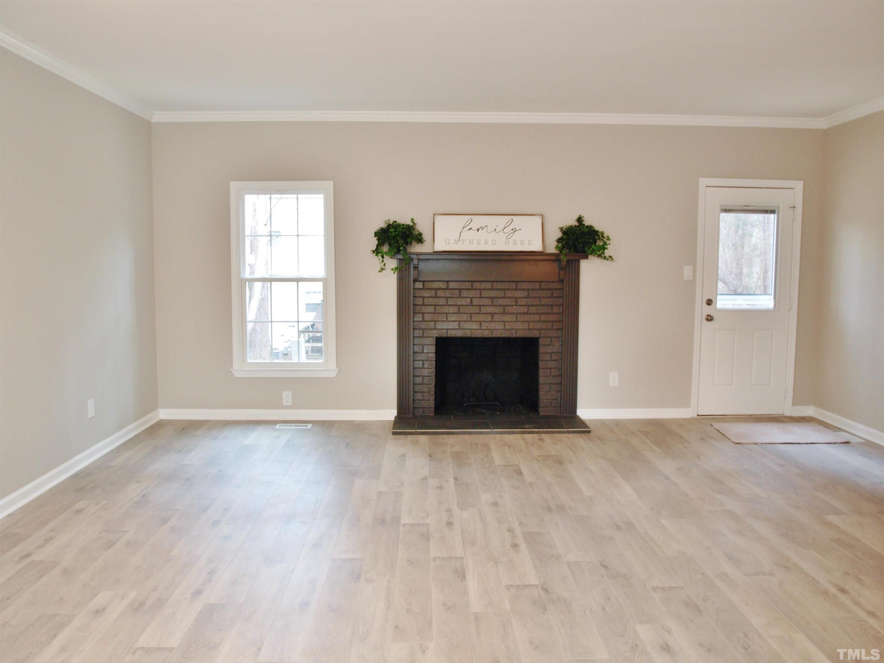 6123 Bushmills Street Raleigh, NC 27613 - Photo 7 of 16 an empty room with windows and fireplace