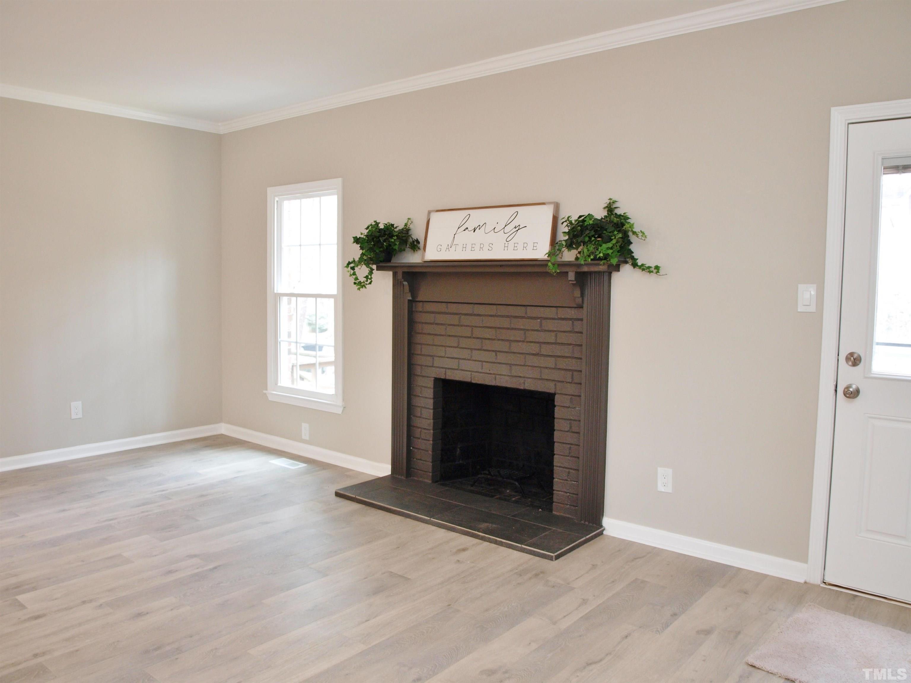 6123 Bushmills Street Raleigh, NC 27613 - Photo 8 of 16 an empty room with windows and fireplace