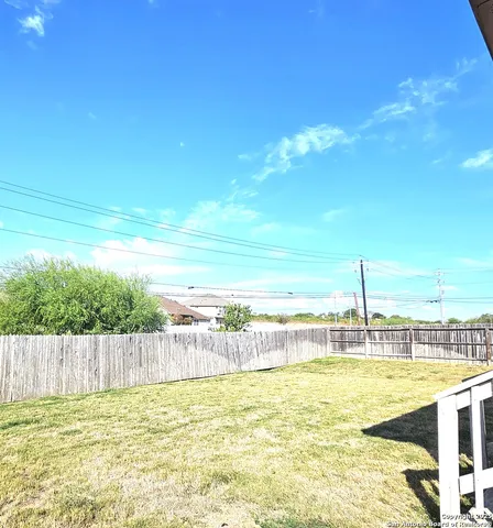 a view of a backyard with swimming pool